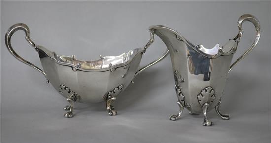 A George V Asprey & Co Ltd silver helmet shaped cream jug and boat shaped two handled sugar bowl, 16.5 oz.